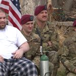 Talan Summers poses with soldiers who gathered at his home.