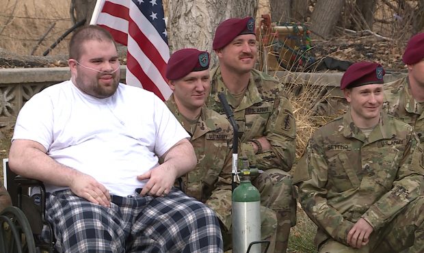 Talan Summers poses with soldiers who gathered at his home....