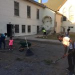Community  members cleaning up outside building 