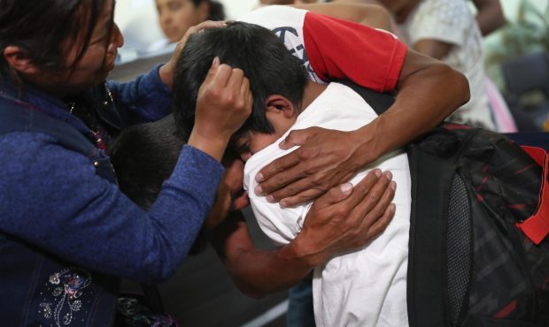 Parents embrace their son for the first time in months on August 7, 2018, in Guatemala City, Guatem...