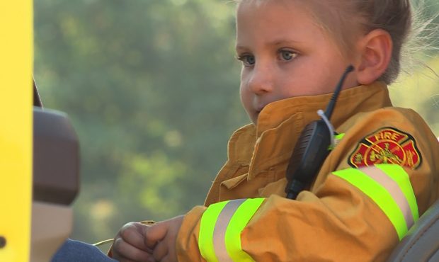Samantha Osburn, age 4, takes a break in the driver's seat of a fire truck dispatched to fight the ...