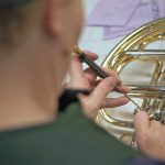 Windy Shaffer works on a french horn in her Spanish Fork shop.  (October 9, 2018)