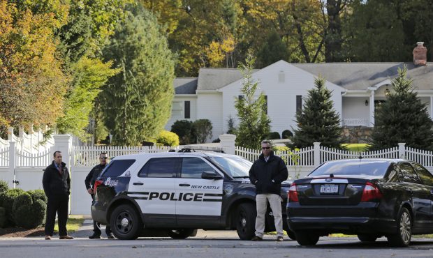 Police officers stand in front of property owned by former Secretary of State Hillary Clinton and f...