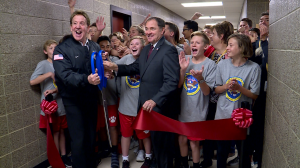 Governor Gary Herbert stands with Jake Steinfeld and students in a ribbon cutting ceremony to celebrate Clayton Middle School's new fitness center.