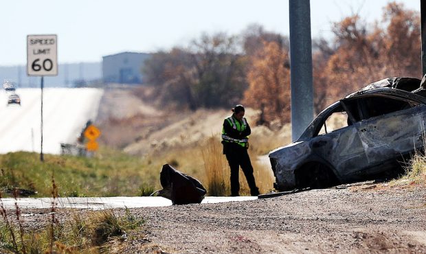 Officials work at the scene of a fatal automobile crash in Magna on Monday, Nov. 12, 2018....
