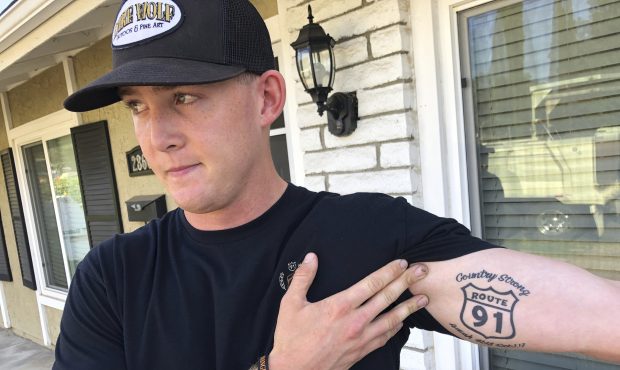 Brendan Kelly speaks with reporters outside his home, as he shows his Route 91 tattoo, Thursday, No...