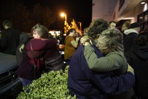 Eva Mills, right, and Holden Grzywacz, two survivors of the Las Vegas mass shooting, mourn the death of Sean Adler during a vigil at the Rivalry Roasters coffee shop Thursday, Nov. 8, 2018, in Simi Valley, Calif. Adler was killed in Wednesday night's shooting at the Borderline Bar and Grill in Thousand Oaks, Calif. (AP Photo/Jae C. Hong)