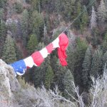 The flag had numerous bundle points that kept it under control in the wind. It was released after it was out over the canyon.