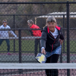 Julie Kanouse serves in a game of pickleball.