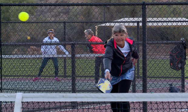 Julie Kanouse serves in a game of pickleball....
