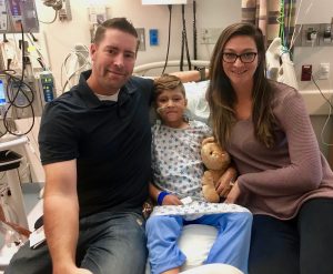 Blake, Mikah and Aubrey Arvidson at Primary Children's Hospital after an emergency surgery to remove fidget magnets from Mikah's intestines.