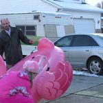 Emily Blodgett's husband and daughter help prepare the scene in their front yard. (December 12, 2018)