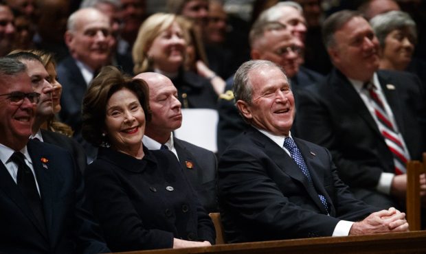 Jeb Bush, Laura Bush, and former President George W. Bush share a laugh as a story is told about fo...