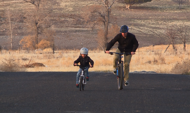 Owen Jones rides bikes outside with his dad, Jason Jones....
