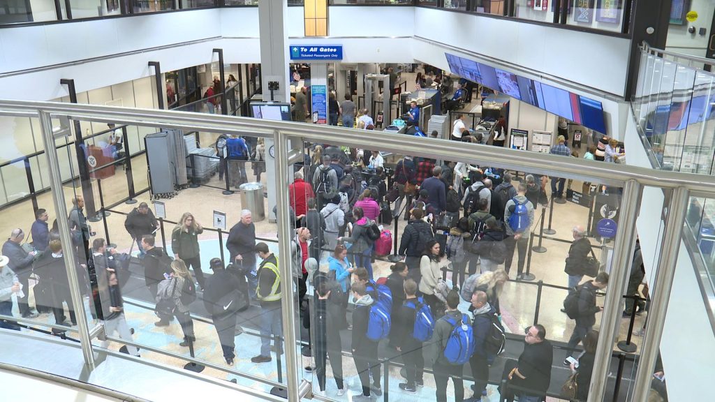 Travelers go through the TSA checkpoint in the Salt Lake City airport.