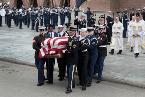 HOUSTON, TX - DECEMBER 06: The flag-draped casket of President George H.W. Bush is carried from St. Martin's Episcopal Church following his funeral service December 6, 2018 in Houston, Texas. Bush, who died on November 30, will be buried on the campus of Texas A&M University behind his library center in College Station, Texas. (Photo by Scott Olson/Getty Images)