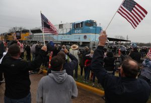 NAVASOTA, TEXAS - DECEMBER 06: People wave at the train carrying the casket of former U.S. President George H.W. Bush to the George H.W. Bush Presidential Library at Texas A&M University on December 6, 2018 in Navasota, Texas. President Bush will be buried at his final resting place at the George H.W. Bush Presidential Library at Texas A&M University in College Station, Texas. A WWII combat veteran, Bush served as a member of Congress from Texas, ambassador to the United Nations, director of the CIA, vice president and 41st president of the United States. (Photo by Justin Sullivan/Getty Images)