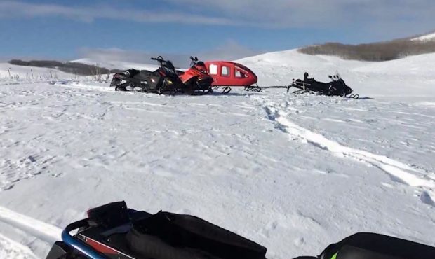 Snowmobiles sit on the island in Strawberry Reservoir after ice fishers were rescued. Photo: Wasatc...