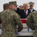 DOVER, DE - JANUARY 19: U.S. President Donald Trump salutes as a military carry team moves the transfer case containing the remains of Scott A. Wirtz during a dignified transfer at Dover Air Force Base, January 19, 2019 in Dover, Delaware. Wirtz was a former Navy Seal who worked for the Defense Intelligence Agency and was one of four Americans killed by a suicide bomber on January 16 in Manbij, Syria. (Photo by Mark Wilson/Getty Images)