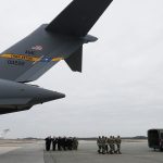 DOVER, DE - JANUARY 19:  U.S. President Donald Trump (L) stands with the official party as a military carry team moves the transfer case containing the remains of Scott A. Wirtz during a dignified transfer at Dover Air Force Base, January 19, 2019 in Dover, Delaware. Wirtz was a former Navy Seal who worked for the Defense Intelligence Agency and was one of four Americans killed by a suicide bomber on January 16 in Manbij, Syria.  (Photo by Mark Wilson/Getty Images)