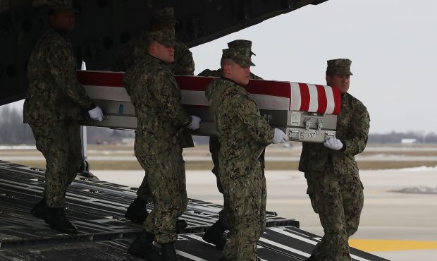 DOVER, DE - JANUARY 19: A U.S. military carry team moves the transfer case containing the remains o...