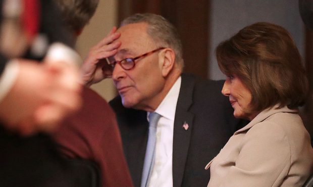 Speaker of the House Nancy Pelosi (D-CA) and Senate Minority Leader Charles Schumer (D-NY) watch a ...