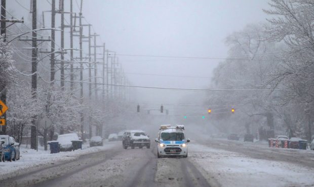 FILE: Cars navigate snow-covered streets on 800 South in Salt Lake City during a winter storm on Mo...