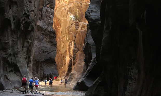 Visitors explore The Narrows along the Virgin River on July 15, 2014 in Zion National Park, Utah. Z...