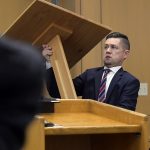 prosecuting attorney Spencer Walsh sets up a podium, preparing for closing arguments in Torrey Green's rape trial, Wednesday, Jan.16, 2019 in Brigham City, Utah. Green is accused of raping multiple women while he was a football player at Utah State University. (Eli Lucero/Herald Journal via AP)