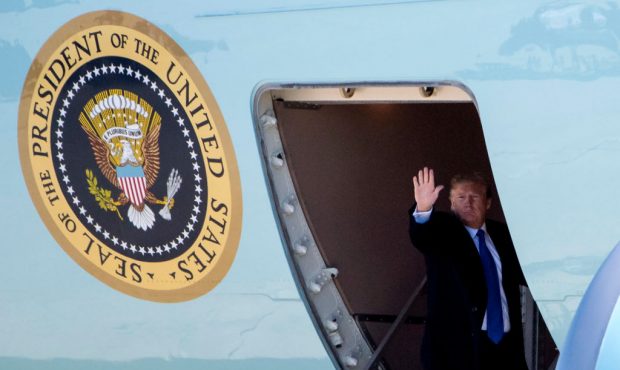 JOINT BASE ANDREWS, MD - FEBRUARY 25: (AFP-OUT) President Donald Trump waves as he boards Air Force...