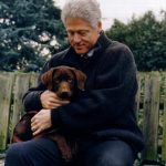 President Bill Clinton with his dog, a three month old choclate labrador puppy. 