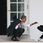 U.S. President Barack Obama greets his dog Bo outside the Oval Office of the White House March 15, 2012 in Washington, DC.  (Photo by Martin H. Simon-Pool/Getty Images)