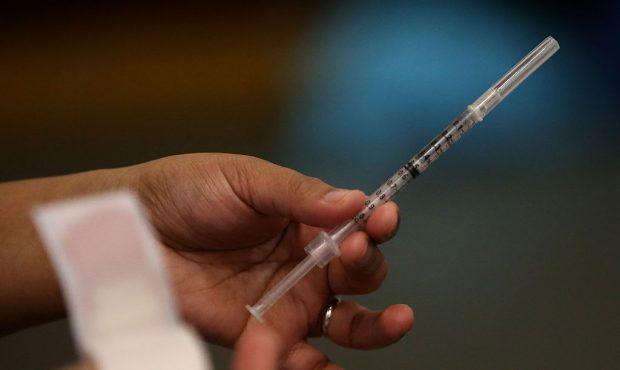 A Walgreens employee holds a syringe during a free flu shot clinic at Allen Temple Baptist Church o...