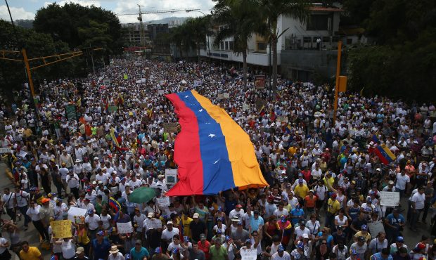 CARACAS, VENEZUELA - MARCH 02:  Carrying a giant Venezuelan flag, thousands of anti-government prot...