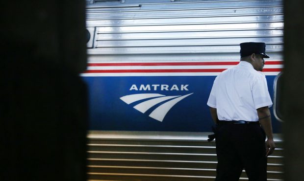 NEW YORK, NY - FEBRUARY 16:  A train conductor stands next to an Amtrak train at New York's Pennsyl...