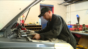 Mechanic Jared Fordham working in one of his work bays in his shop