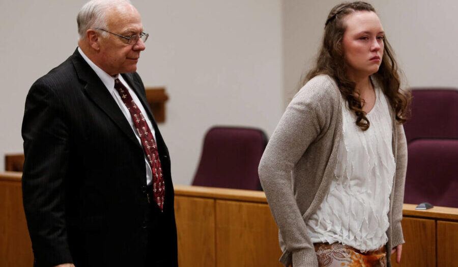 Defense attorney Dean Zabriskie and his client Meagan Grunwald walk back to their table during a sh...