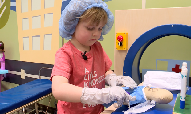Four-year-old Corbin Cox loves playing "doctor" with the child life specialists at Primary Children...