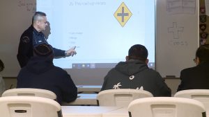 Manny Escoto teaches road signs in his traffic class.