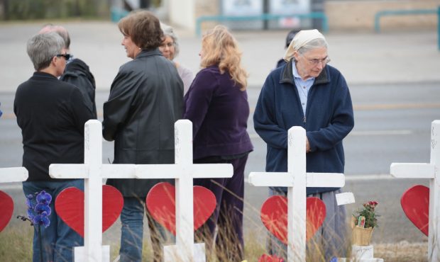 SUTHERLAND SPRINGS, TX - NOVEMBER 10:  Visitors pay respects at a memorial where 26 crosses were pl...