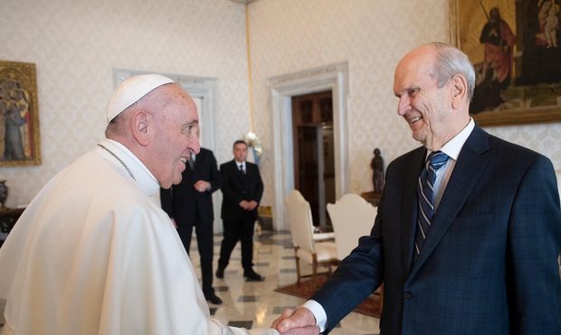 Pope Francis shakes hands with Church of Jesus Christ of Latter-day Saints President Russell M. Nel...