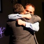 LITTLETON, COLORADO - APRIL 18: Columbine High School teacher Tom Tonelli (L) hugs former Columbine principal Frank DeAngelis at a remembrance service on April 18, 2019 in Littleton, Colorado. Ireland was seriously wounded in the 1999 Columbine High School shooting. The service marks the 20th anniverssary of the 1999 massacre at Columbine High School where 12 students and a teacher were killed. (Photo by Rick Wilking-Pool/Getty Images)