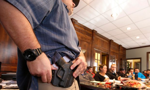 PROVO, UT - DECEMBER 19: Damon Thueson shows a holster at a gun concealed carry permit class put on...