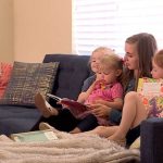 Janssen Bradshaw reads with her three of her girls.