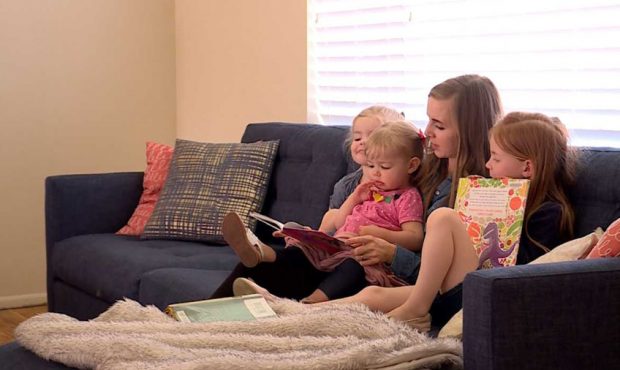 Janssen Bradshaw reads with her three of her girls....