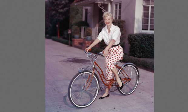 American actor Doris Day poses on a red Schwinn bicycle, late 1950s. (Photo by Hulton Archive/Getty...