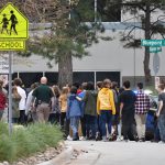 HIGHLANDS RANCH, COLORADO - MAY 07: Students move towards a school bus to be evacuated from the scene of a shooting in which at least seven students were injured at the STEM School Highlands Ranch on May 7, 2019 in Highlands Ranch, Colorado.  (Photo by Tom Cooper/Getty Images)