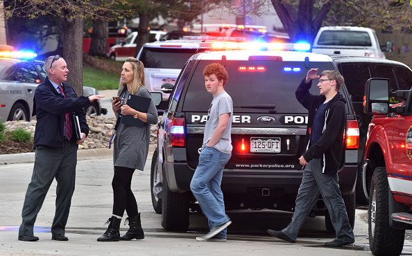 HIGHLANDS RANCH, COLORADO - MAY 07: A teacher and students are directed away from the scene of a sh...