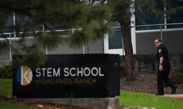 HIGHLANDS RANCH, CO - MAY 08: A police officer walks past the STEM School Highlands Ranch entrance ...