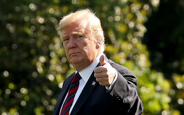 U.S. President Donald Trump gives a thumbs up as he walks toward Marine One while departing from th...
